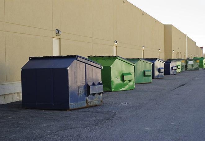 a collection of bright and vibrant dumpsters in a construction zone in Eldridge